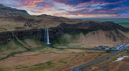 Aerial View of Seljalandsfoss Waterfall with Scenic Valley and Pink Skyの写真素材