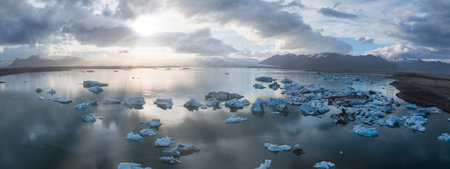 Aerial View of Glacial Lagoon with Icebergs and Mountain Range in Iceland