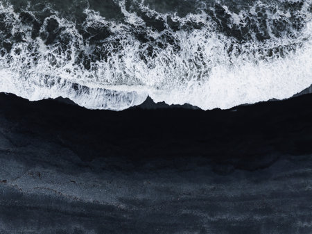 Aerial View of Black Sand Beach with Breaking Waves in Iceland