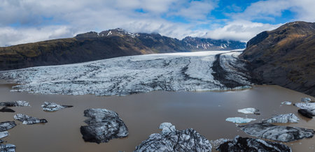 Aerial View of Glacial Lake Surrounded by Mountains and Glaciers in Iceland