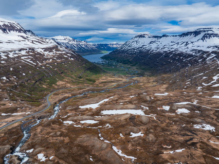 Aerial View of Snow-Capped Mountain Range and River Valley in Icelandの写真素材