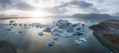 Aerial View of Glacial Lagoon with Icebergs and Snow-Capped Mountains in Iceland
