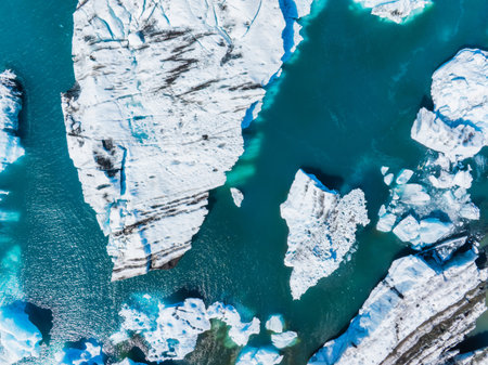 Aerial view of the big pieces of ice from glacier, ice islands, glacier and mountains, Jokulsarlon