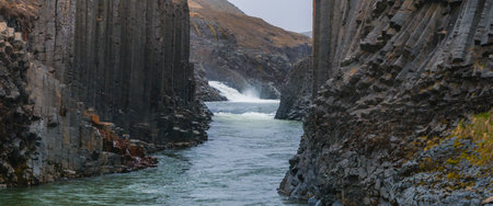 Aerial View of Whitewater River Flowing Through Steep Canyon in Icelandの写真素材