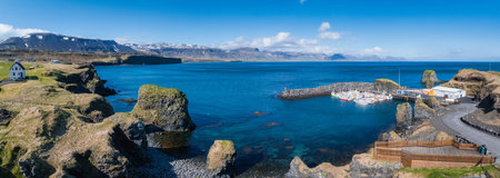 Aerial View of a Small Harbor on a Rocky Peninsula in Iceland