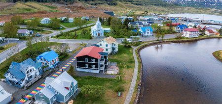 Aerial View of a Picturesque Icelandic Town on a Peninsula with Lake and Riverの写真素材