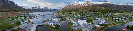 The famous rainbow road in Seydisfjordur with icelandic buildings around show artwork painted walls.の写真素材