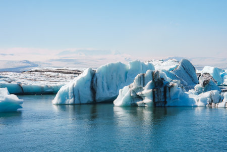 Jokulsarlon Glacier Lagoon with Icebergs and Snow-Covered Mountains in Icelandの写真素材