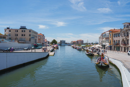 Picturesque Canal with Moliceiro Boats and Colorful Buildings in Aveiro, Portugalの写真素材