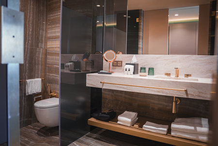 Luxurious Hotel Bathroom with Marble Vanity and Gold Accentsの写真素材