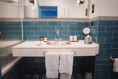 Luxurious Bathroom with Teal Greek Key Tiles and Polished Silver Faucetの写真素材