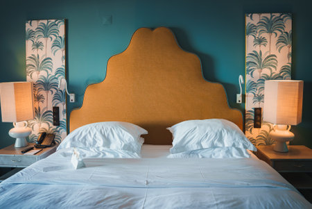 Luxurious Hotel Room with Mustard Scalloped Headboard and Teal Wallの写真素材