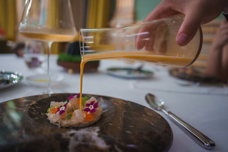 Luxurious Dining Experience with Gourmet Dish and Elegant Table Settingの写真素材