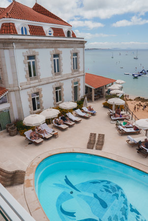 Luxurious Seaside Hotel with Red-Tiled Roof and White Stone Facadeの写真素材