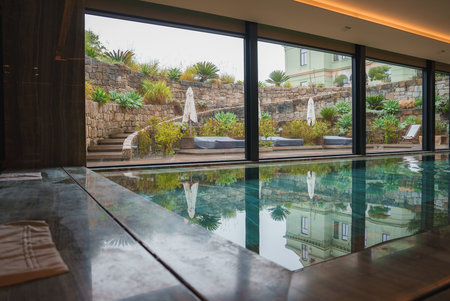Luxurious Indoor Swimming Pool with Terrace View and Modern Architectureの写真素材