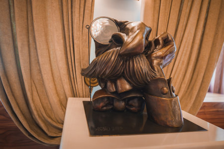 Whimsical Bronze Sculpture with Monocle in Luxurious Hotel Interiorの写真素材