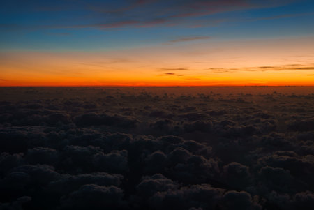 Aerial View of Vibrant Sunset Over Clouds