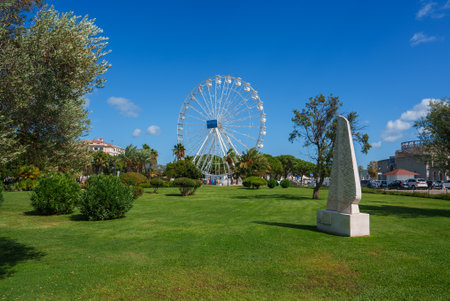 Vibrant Park Scene with Ferris Wheel in Cagliari, Sardiniaの写真素材