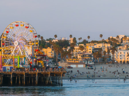 Santa Monica Pier with Ferris Wheel and Amusement Park at Sunsetの写真素材