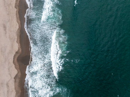 Aerial View of Coastline with Crashing Wavesの写真素材