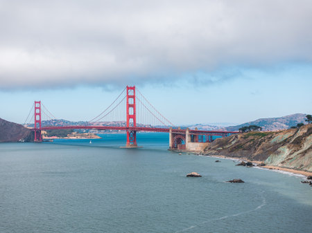 Golden Gate Bridge Spanning San Francisco Bay Under Partly Cloudy Skyの写真素材