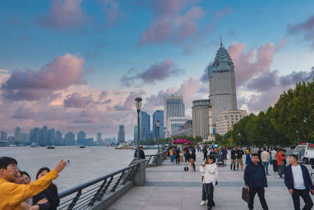 Bustling Promenade Along the Bund with Shanghai Skylineの写真素材