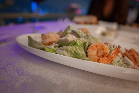 Close Up of Caesar Salad with Grilled Shrimp on White Plateの写真素材