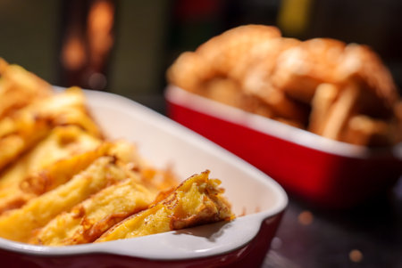 Close Up of Golden Crispy Pastry Slices in Red Baking Dish