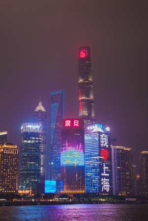 Shanghai Skyline at Night with Illuminated Skyscrapers and Reflectionsの写真素材