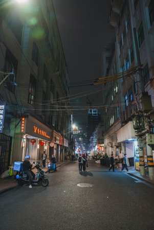 Nighttime Street Scene in Shanghai with Neon Signs and Lanternsの写真素材