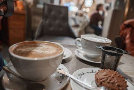 Cozy Cafe Table with Coffee and Dessert in Helsinki, Finlandの写真素材