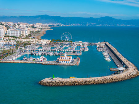 Aerial View of Benalmadena Marina with Ferris Wheel and Coastlineの写真素材