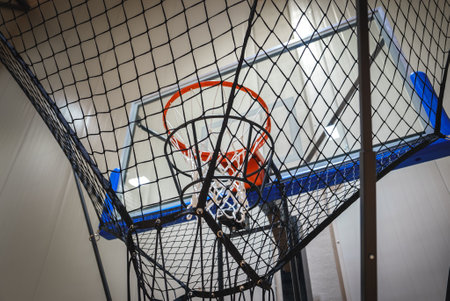 Close Up of Basketball Hoop with Netted Return System in Modern Facility