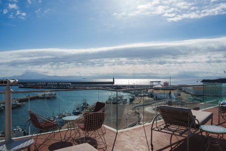 Rooftop Terrace Overlooking Marina with Boats and Calm Seaの写真素材