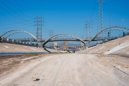 Los Angeles River with Arched Bridges and Electrical Pylonsの写真素材