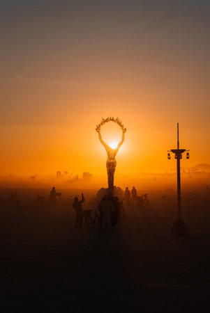 Desert Festival Art Installation Silhouetted Against Vibrant Sunsetの写真素材