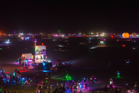 Nighttime Festival Scene with Illuminated Art Installations in Desertの写真素材