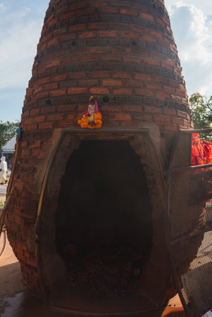 Conical Brick Kiln with Religious Statue in Outdoor Setting, Thailandの写真素材