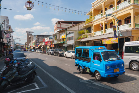 Lively Street Scene with Tuk Tuk in Phuket, Thailand on a Sunny Dayの写真素材