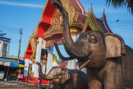 Traditional Thai Temple with Bronze Elephant Statues in Phuketの写真素材