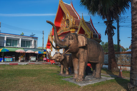 Ornate Buddhist Temple with Elephant Statues in Thailandの写真素材