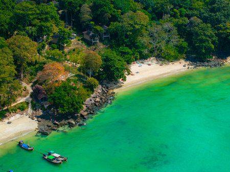 Tropical Beach with Longtail Boats and Turquoise Waters in Thailandの写真素材