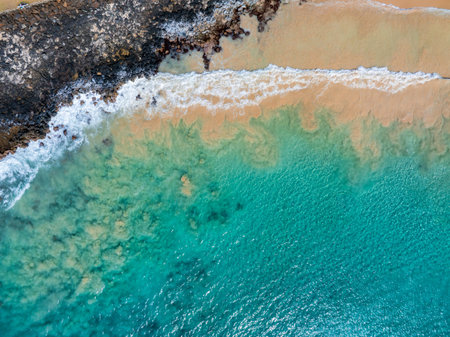 Aerial View of Pristine Beach and Rocky Shoreline on Kauai Islandの写真素材