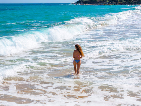 Standing in Shallow Turquoise Water on Kauai Beachの写真素材