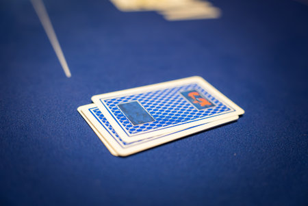 Close Up of Playing Cards on Blue Felt Poker Table