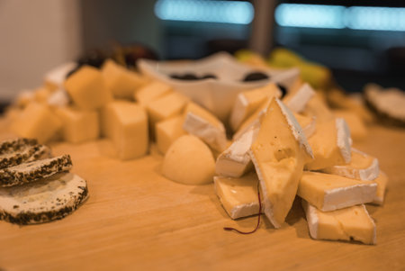 Gourmet Cheese Platter with Brie, Herb Coated Slices, and Olivesの写真素材