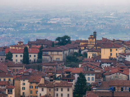 Historic Old Town of Bergamo with Bell Tower at Sunsetの写真素材