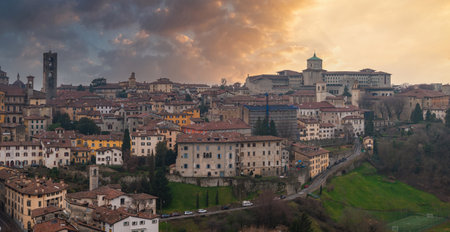 Historic Old Town of Bergamo at Sunset with Bell Tower and Green Domeの写真素材