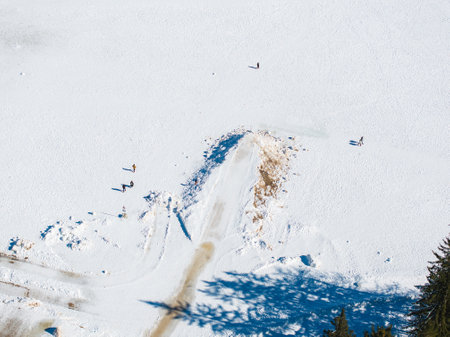 Aerial View of Snow Covered Lake with Walking Pathsの写真素材