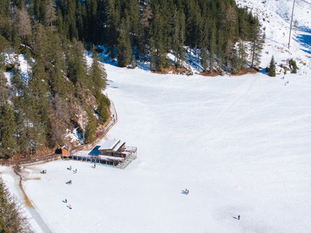 Aerial View of Frozen Braies Lake with Boathouse in Winterの写真素材